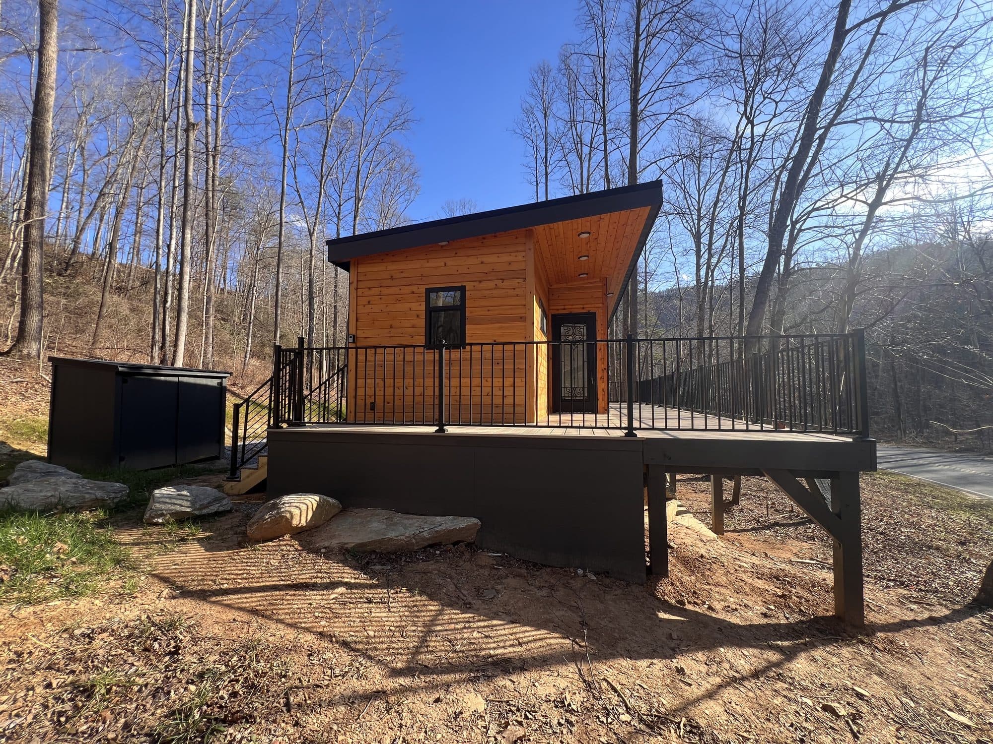 A Sweet-Haus cabin and deck at Trout Stream Cabins under a blue mountain sky